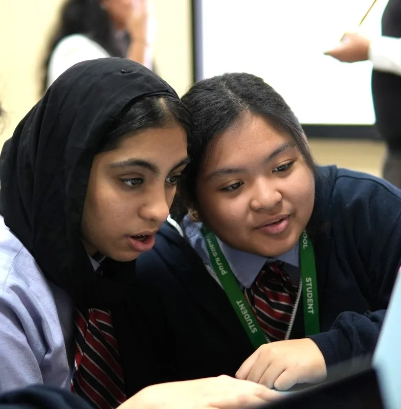 two students looking at screen